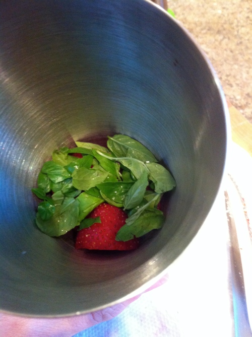 Strawberries and basil in martini shaker read to be muddled...